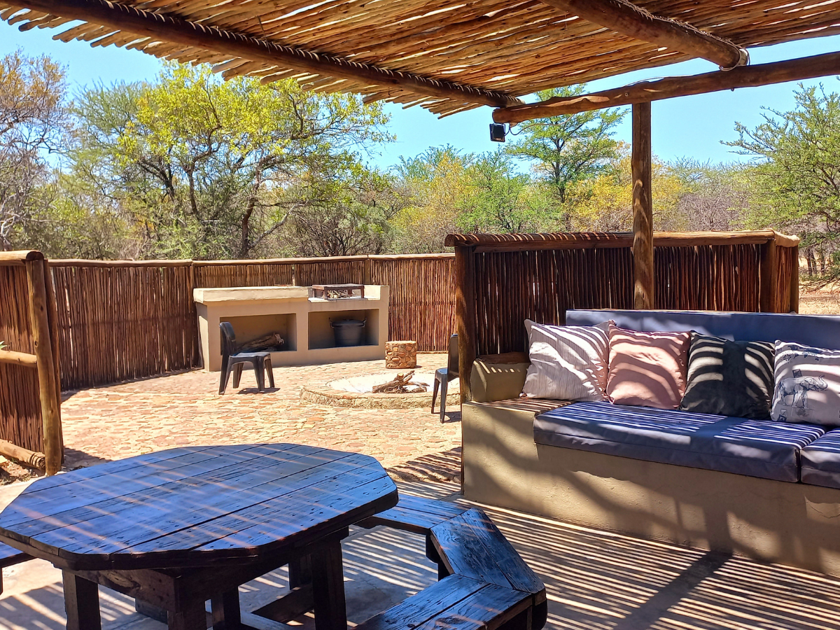 Rock Cottage boma/braai Rock Cottage covered patio with outdoor seating and private boma/braai at Sun Acres Farm